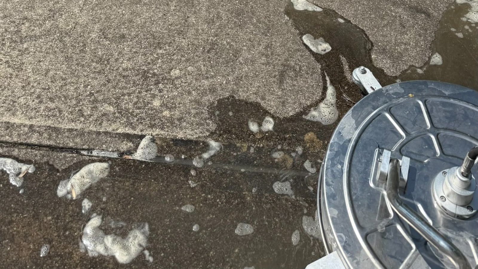 Before: stained driveway
